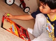 Putting together his Lightening McQueen puzzle